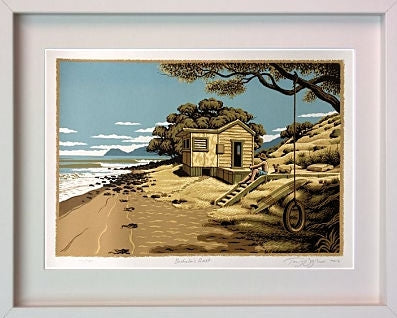 Framed artwork of a beach scene with a small house and tree.