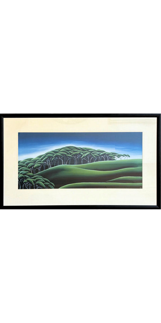 Framed artwork of a landscape with green fields and trees.