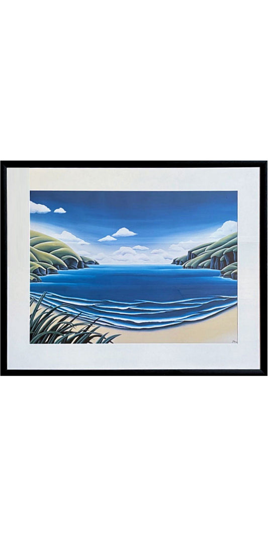 Framed artwork of a coastal scene with blue water and green hills.