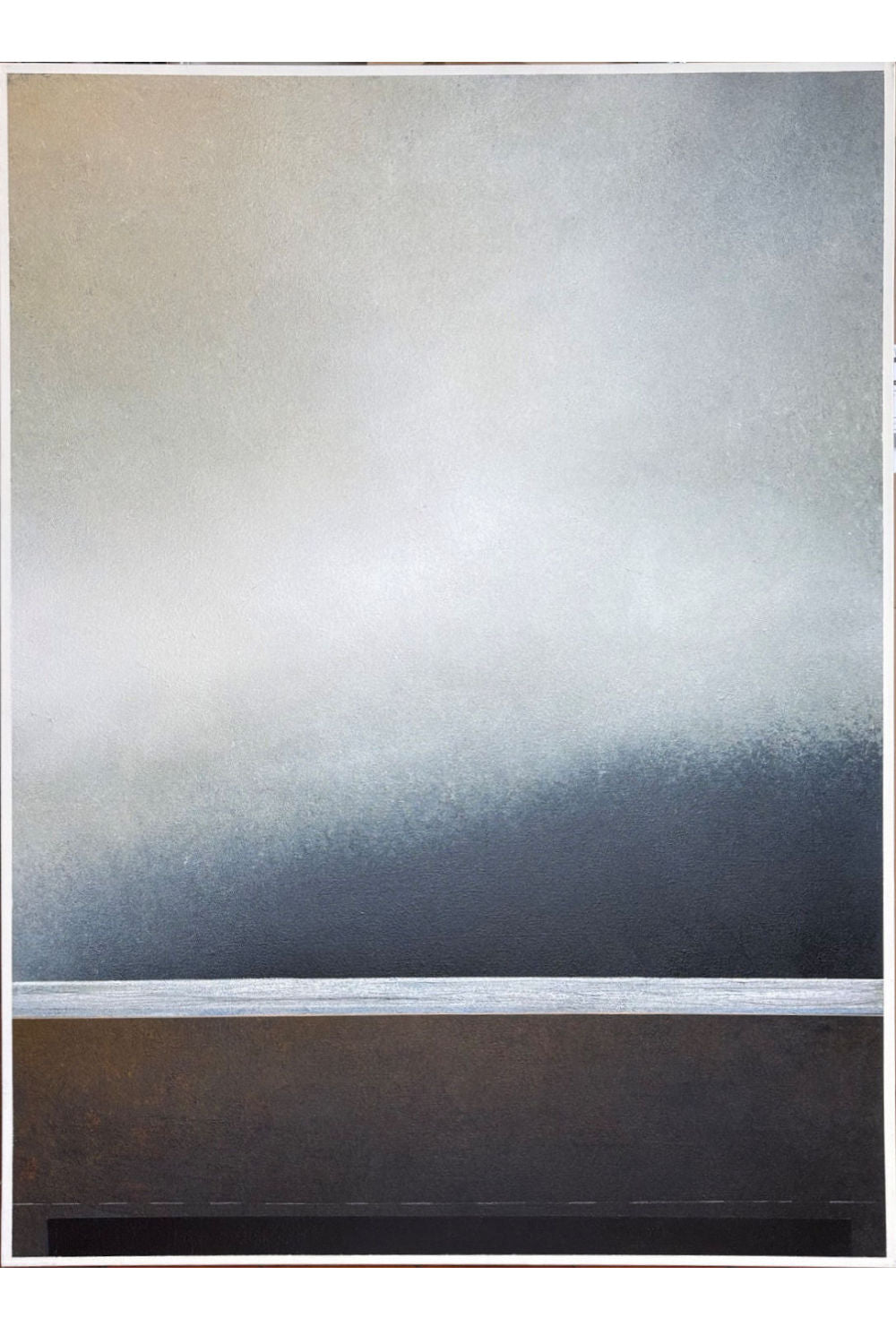 An abstract landscape art print featuring a misty, atmospheric scene with a gradient from light beige and gray at the top to a deep blue-gray in the middle, and a dark brown textured lower section, framed by a thin white border.