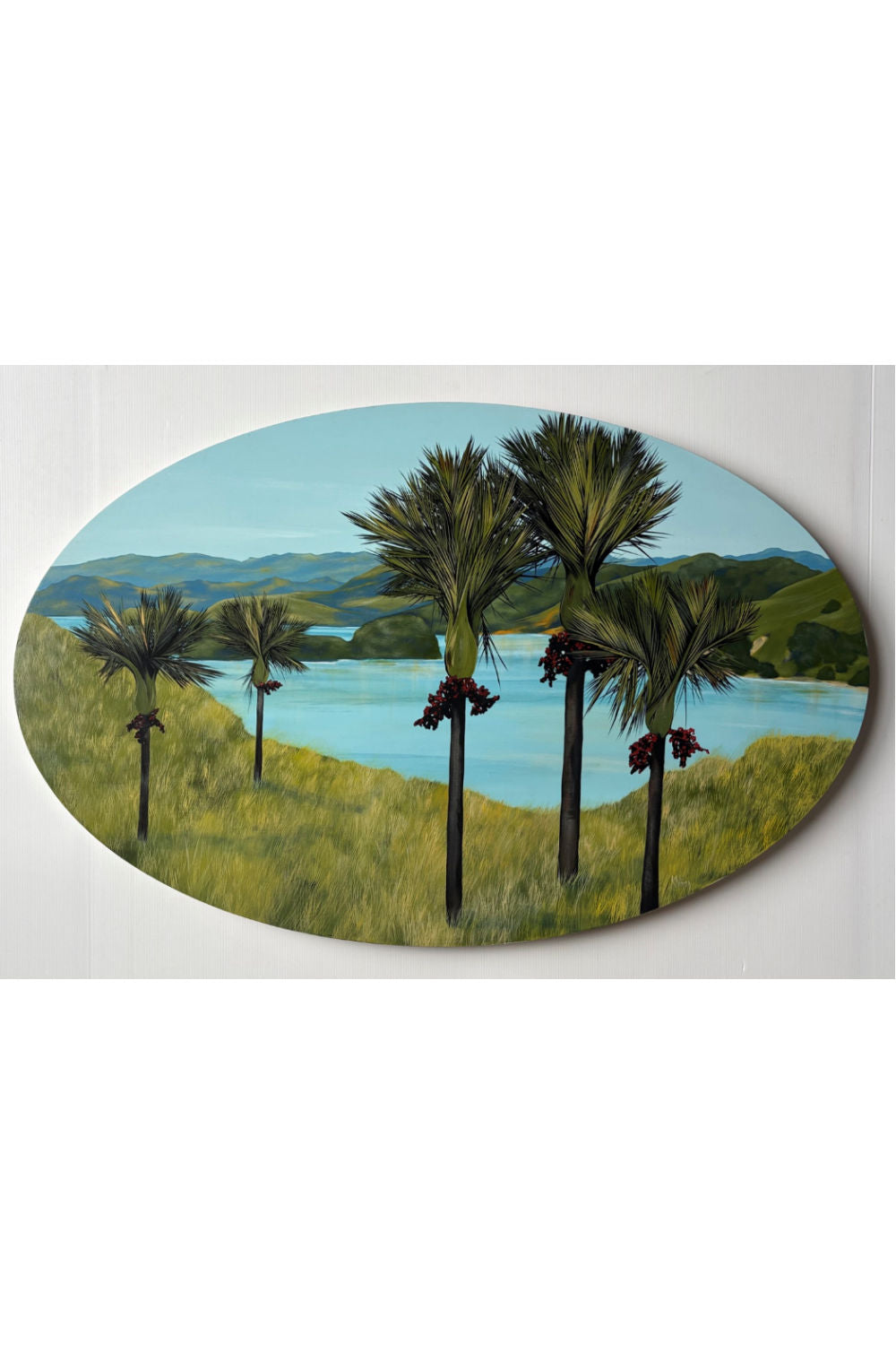 An oval landscape painting of the Coromandel New Zealand in the late afternoon by Kirsty Nixon.